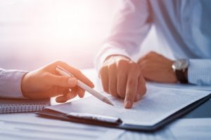 Man signing document of liability