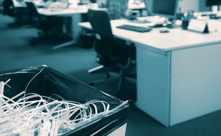 A bin full of shredded papers in an office.