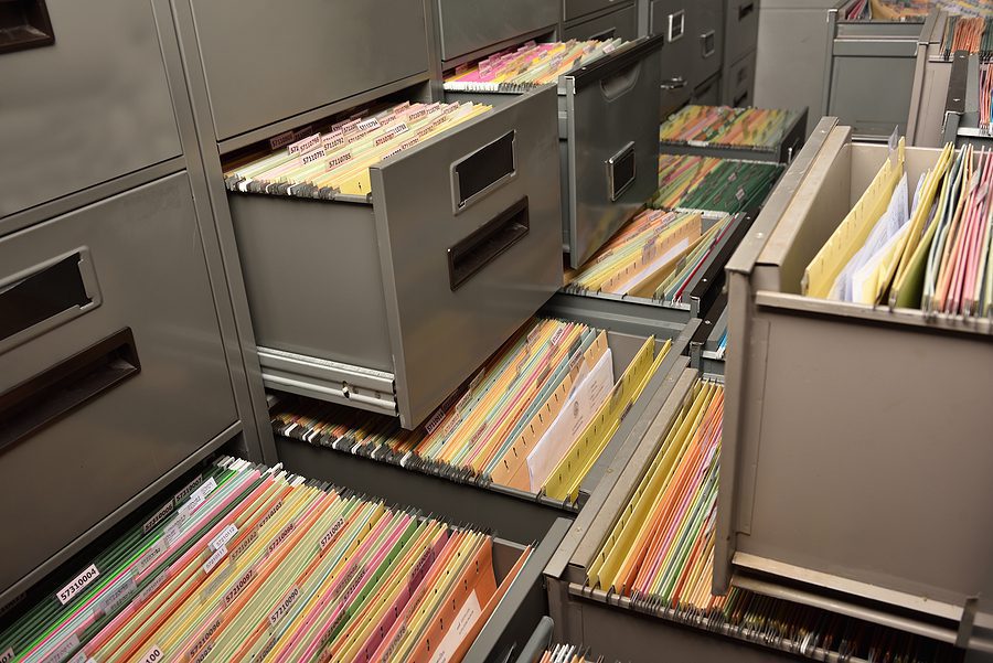 Full file cabinets representing business documents and old files.