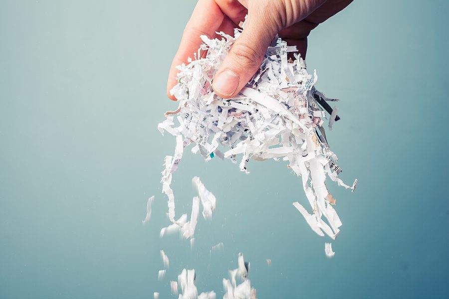 Hand is holding a bunch of shredded paper.