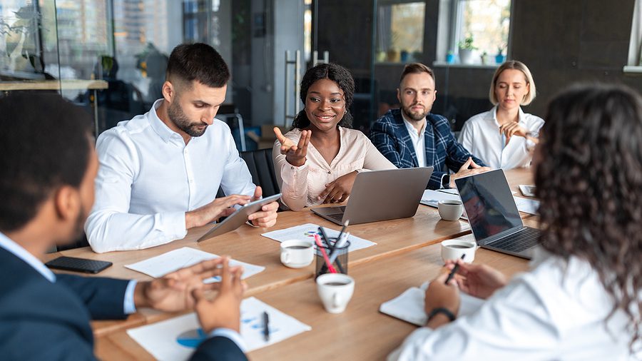 Modern business office meeting in an open concept conference room.