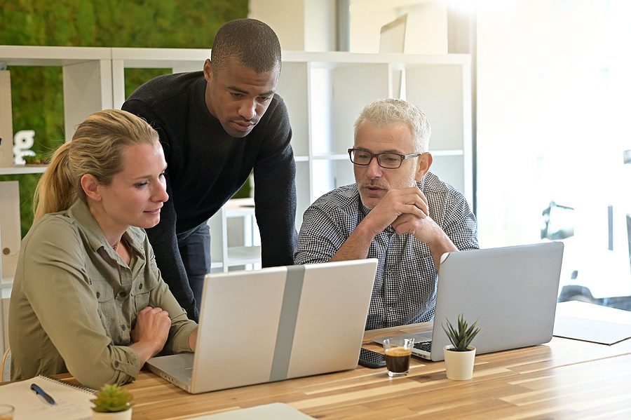 Business people in modern meeting room working together on project.