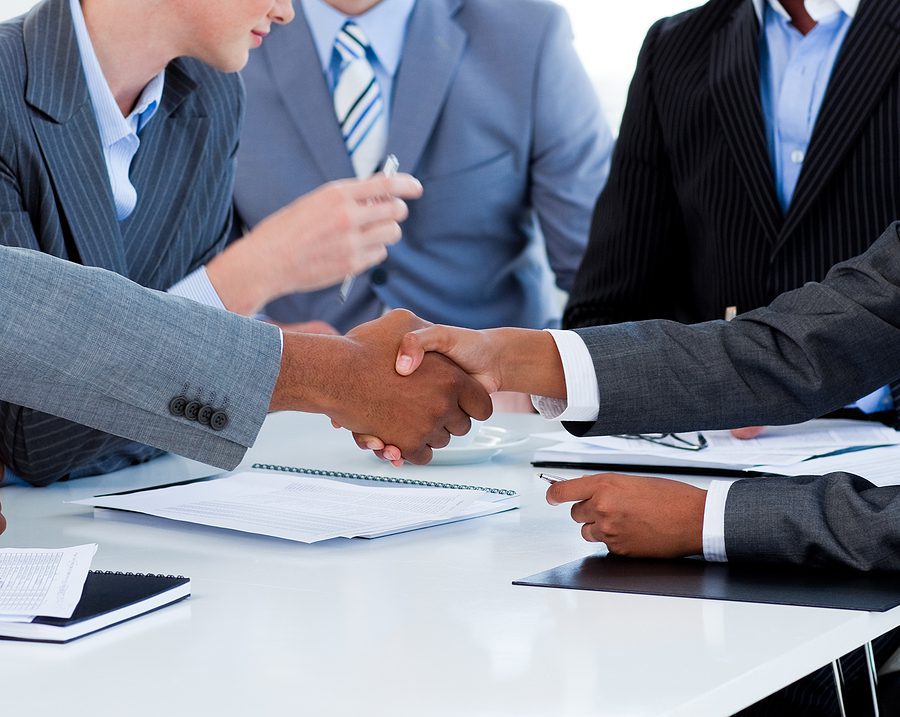 Close-up of business people greeting each other in a meeting.