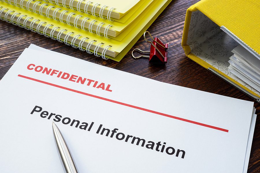 Personal information documents labeled confidential on top.