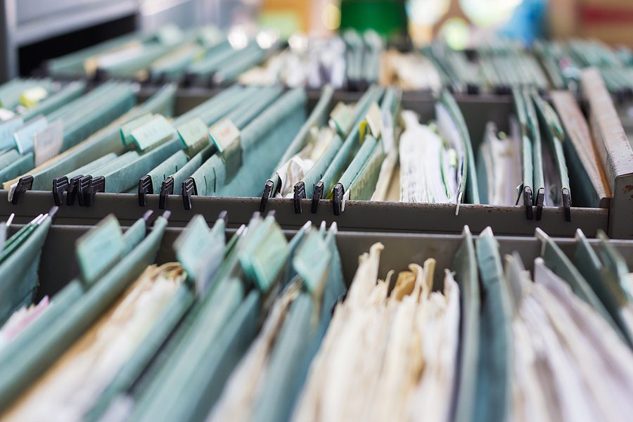 Close Up photo of business file folders in a filing cabinet.