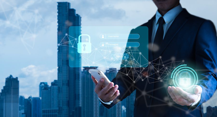 Photo of a business man in front of a city holding a cell phone with overlaying cyber security graphics