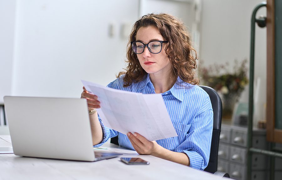 Businesswoman looking at some company paperwork.
