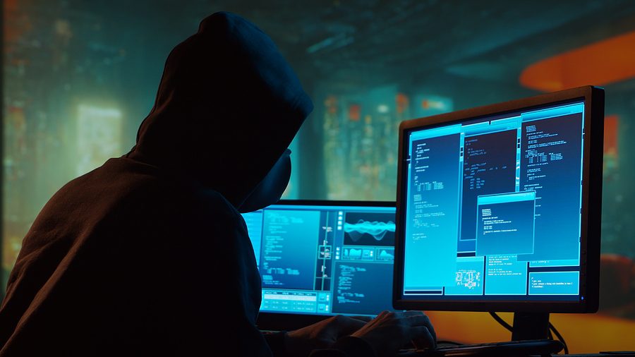 Computer Hacker in Hoodie. Obscured Dark Face. Concept of Hacker Attack, Virus Infected Software, Dark Web and Cyber Security.