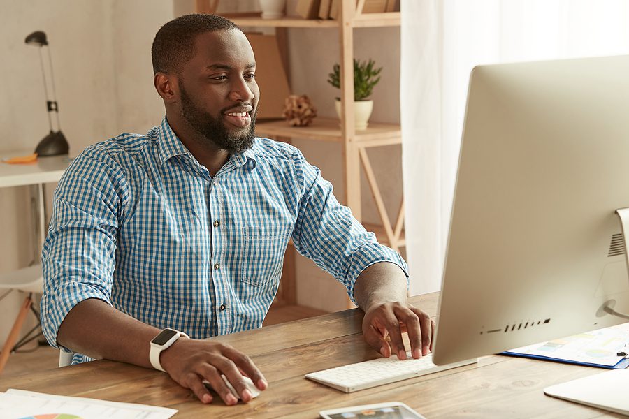 Male businessman working remotely from his home office. 