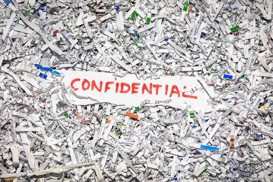 Concept of shredding confidential information to protect identity theft.